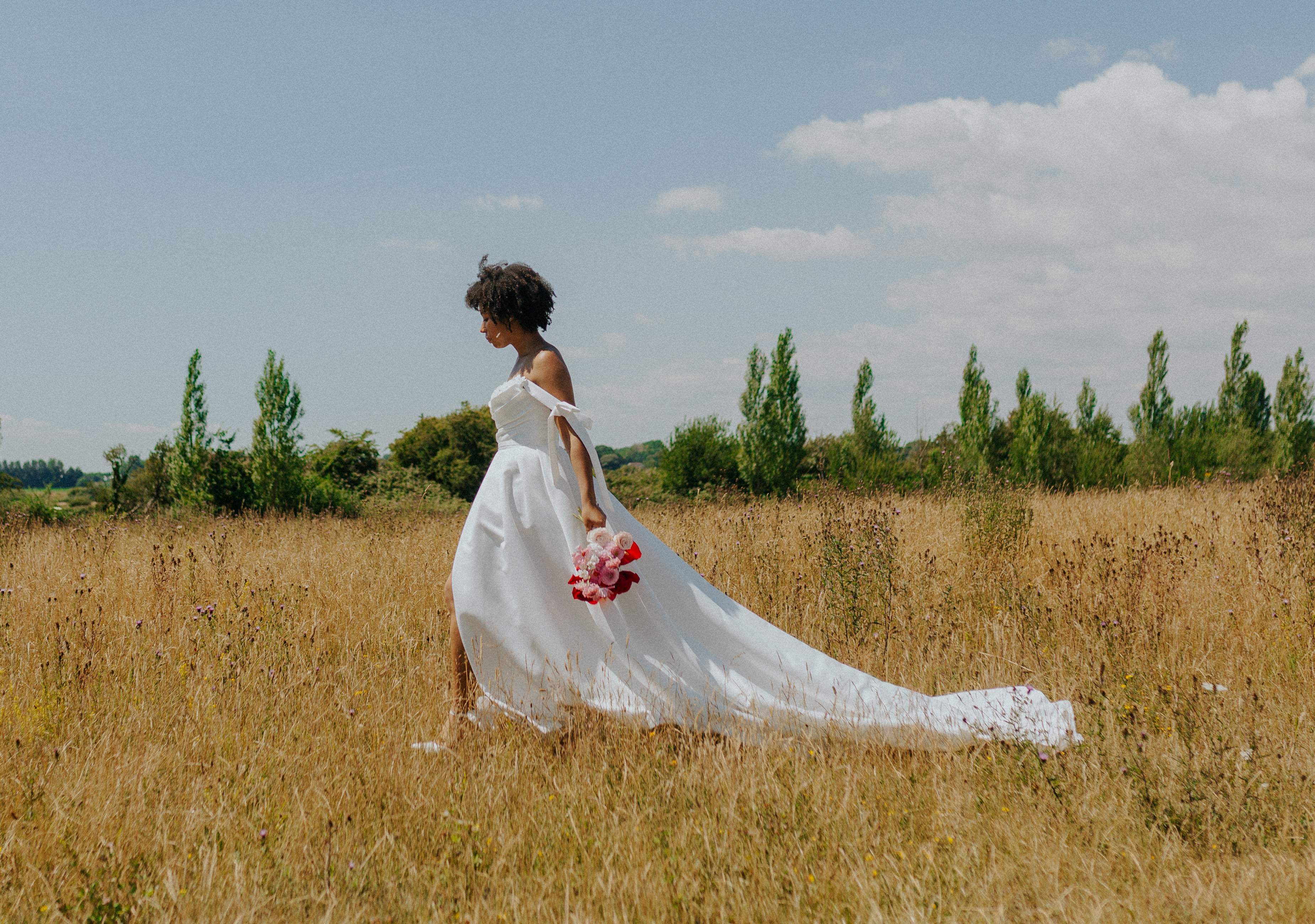Bride with bouquet in golden field