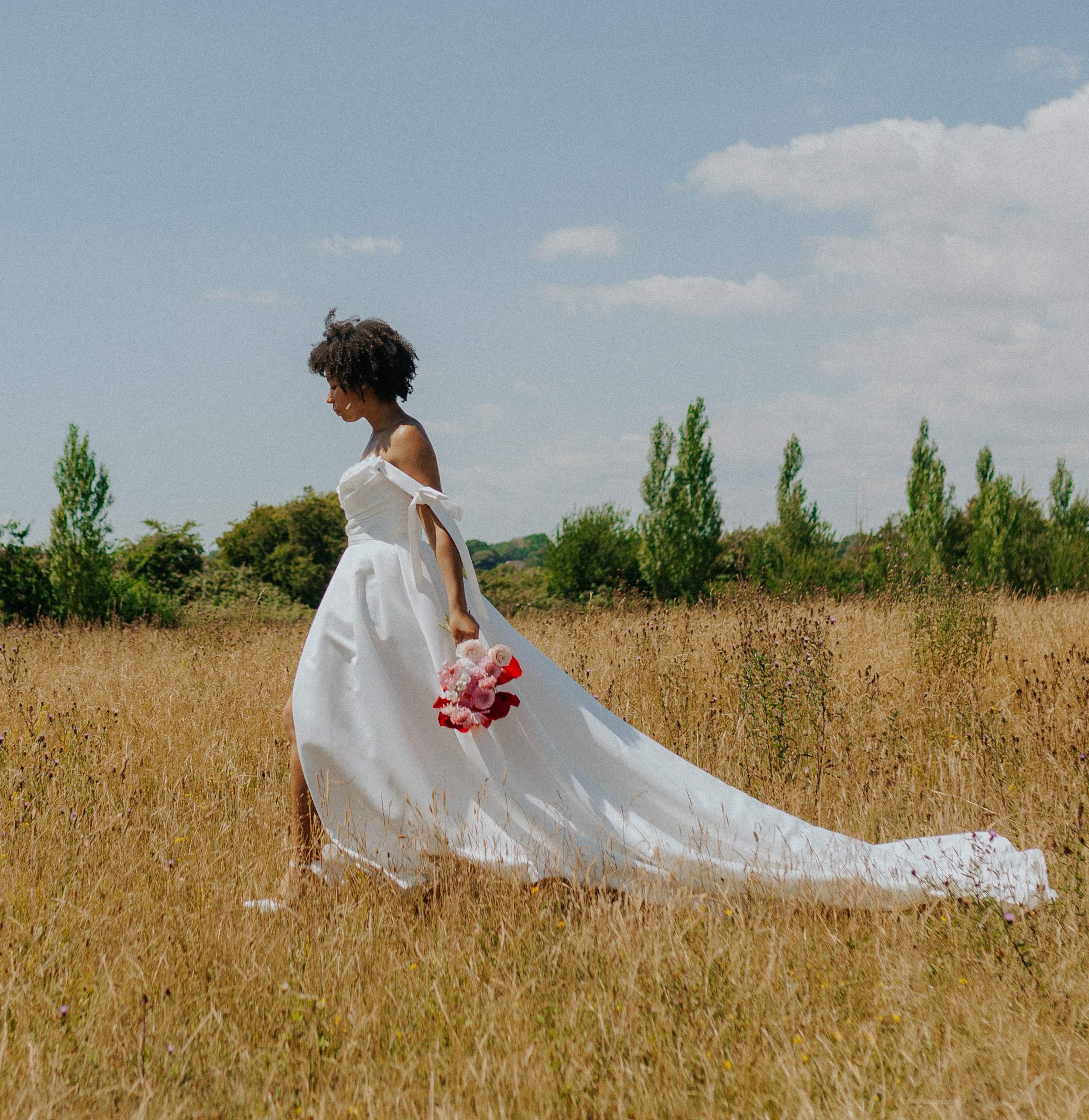 Bride with bouquet in golden field